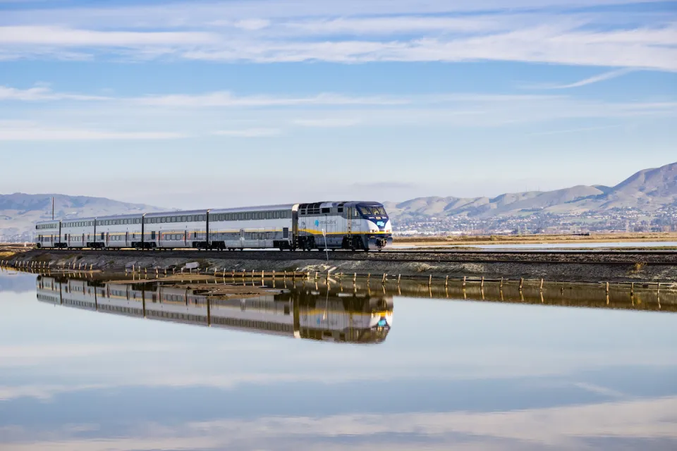 Amtrak train passing over bridge on Alviso Marsh near San Jose, California.